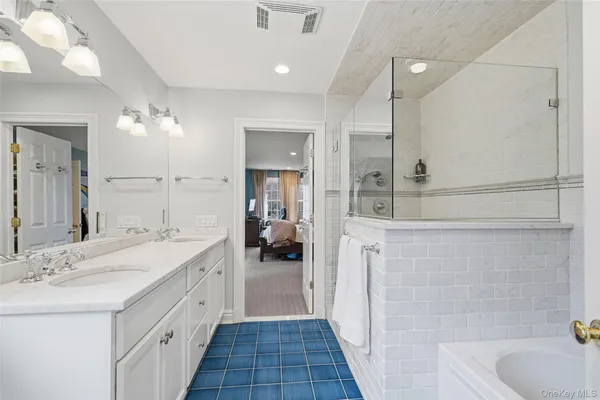 a spacious bathroom with a sink a mirror and a shower