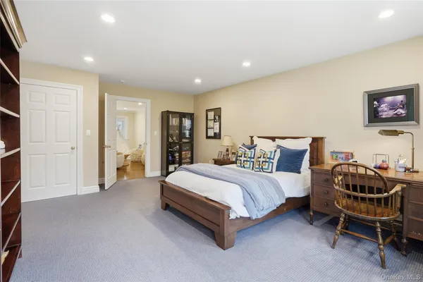 a spacious bedroom with a bed and a desk