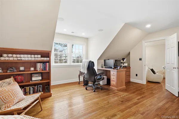 a view of a workspace with furniture and a window