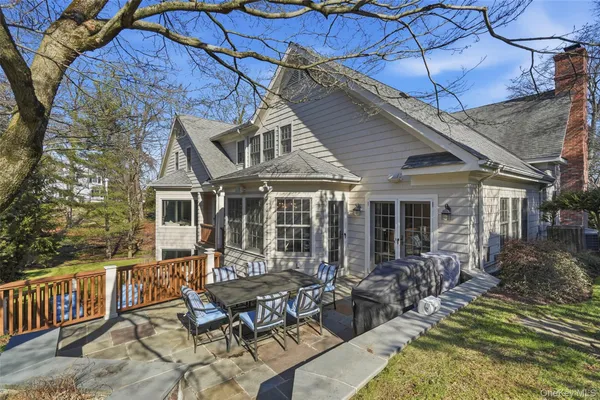 a view of a house with backyard porch and sitting area