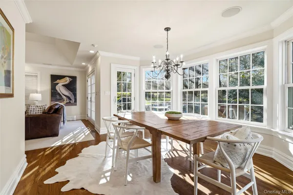a view of a dining room with furniture wooden floor and chandelier