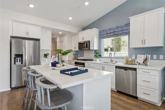 a kitchen with white cabinets and counter space