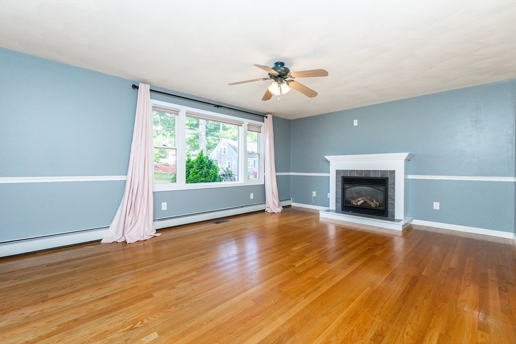 63 Bow Street Saugus, MA 01906 - Photo 3 of 42 a view of an empty room with wooden floor and a window