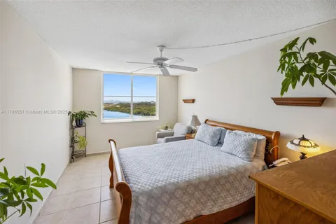 a bedroom with a bed table and a window