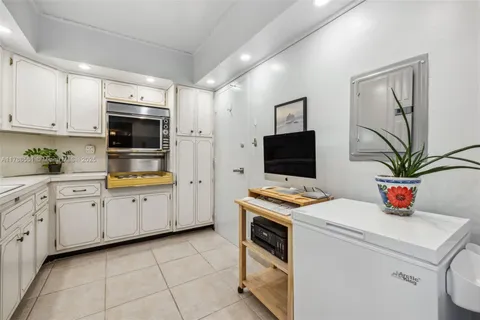 a kitchen with stainless steel appliances a stove refrigerator sink and white cabinets