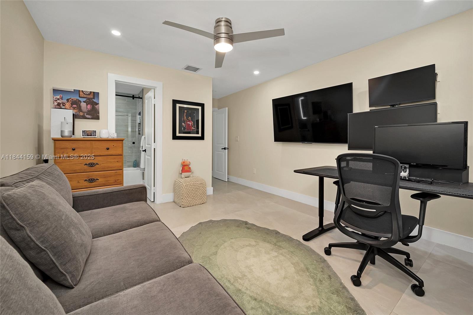 8375 Southwest 78th Street Miami, FL 33143 - Photo 19 of 45 a bedroom with furniture and a flat screen tv