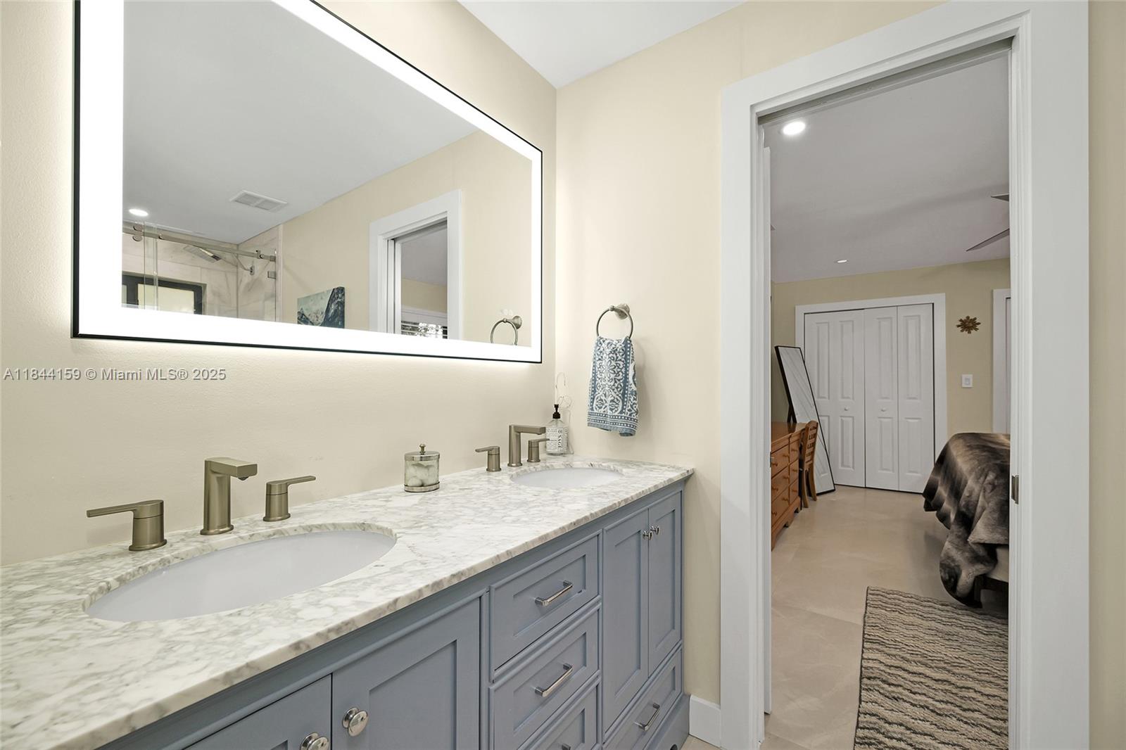 8375 Southwest 78th Street Miami, FL 33143 - Photo 24 of 45 a bathroom with a granite countertop double vanity sink and mirror