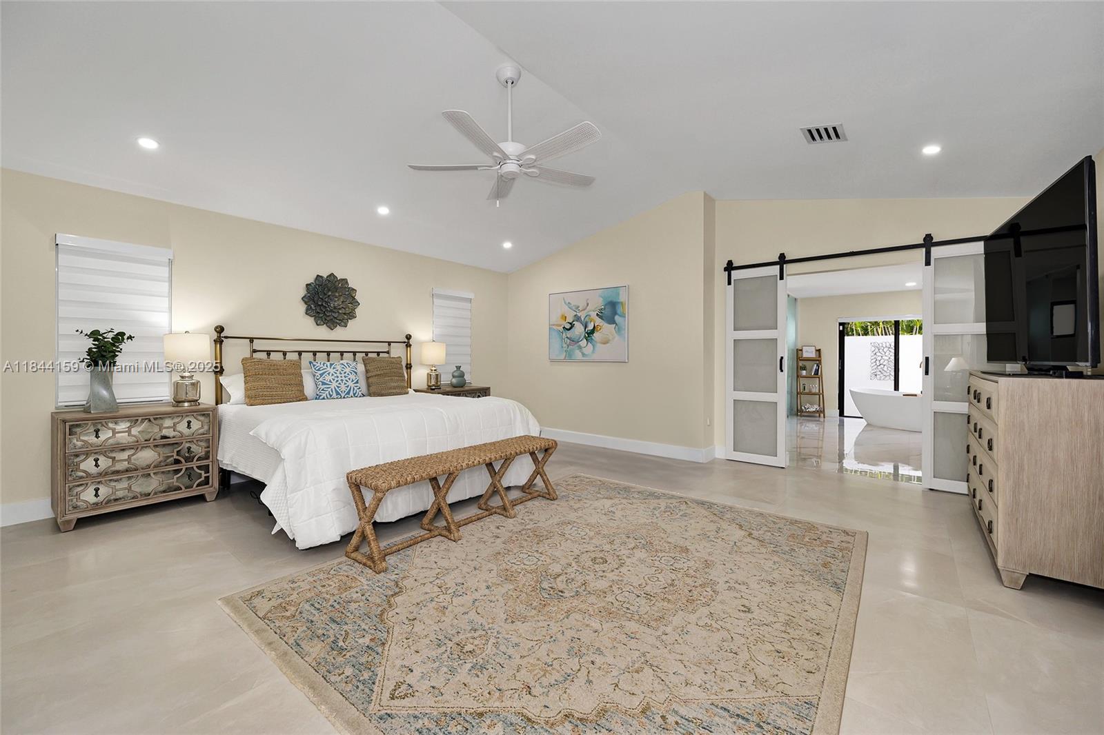 8375 Southwest 78th Street Miami, FL 33143 - Photo 30 of 45 a bedroom with a bed a mirror on dresser and a couch