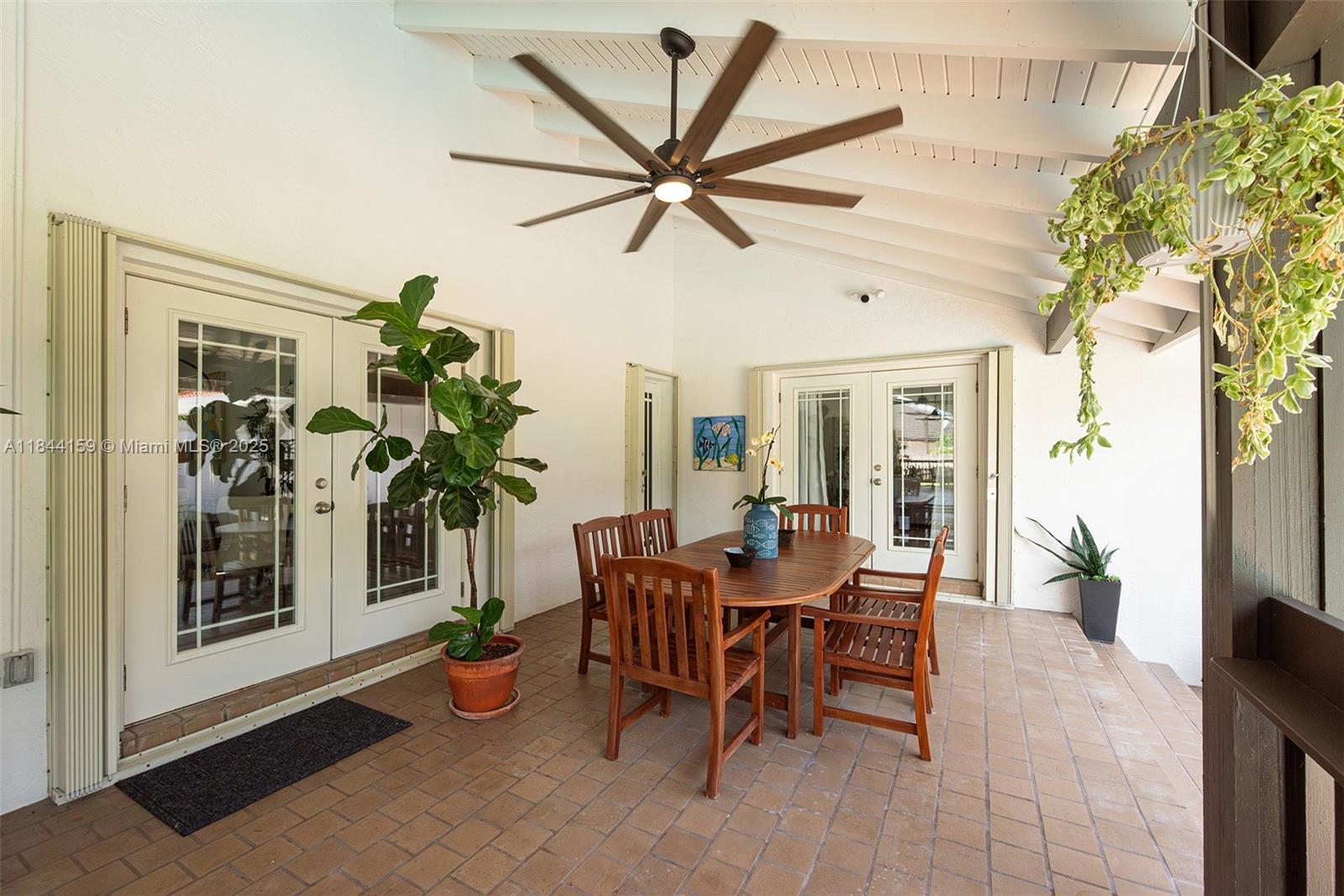 8375 Southwest 78th Street Miami, FL 33143 - Photo 35 of 45 a view of a dining room with furniture and a potted plant
