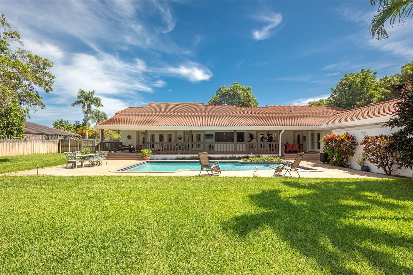 8375 Southwest 78th Street Miami, FL 33143 - Photo 39 of 45 a view of a swimming pool with lawn chairs under an umbrella