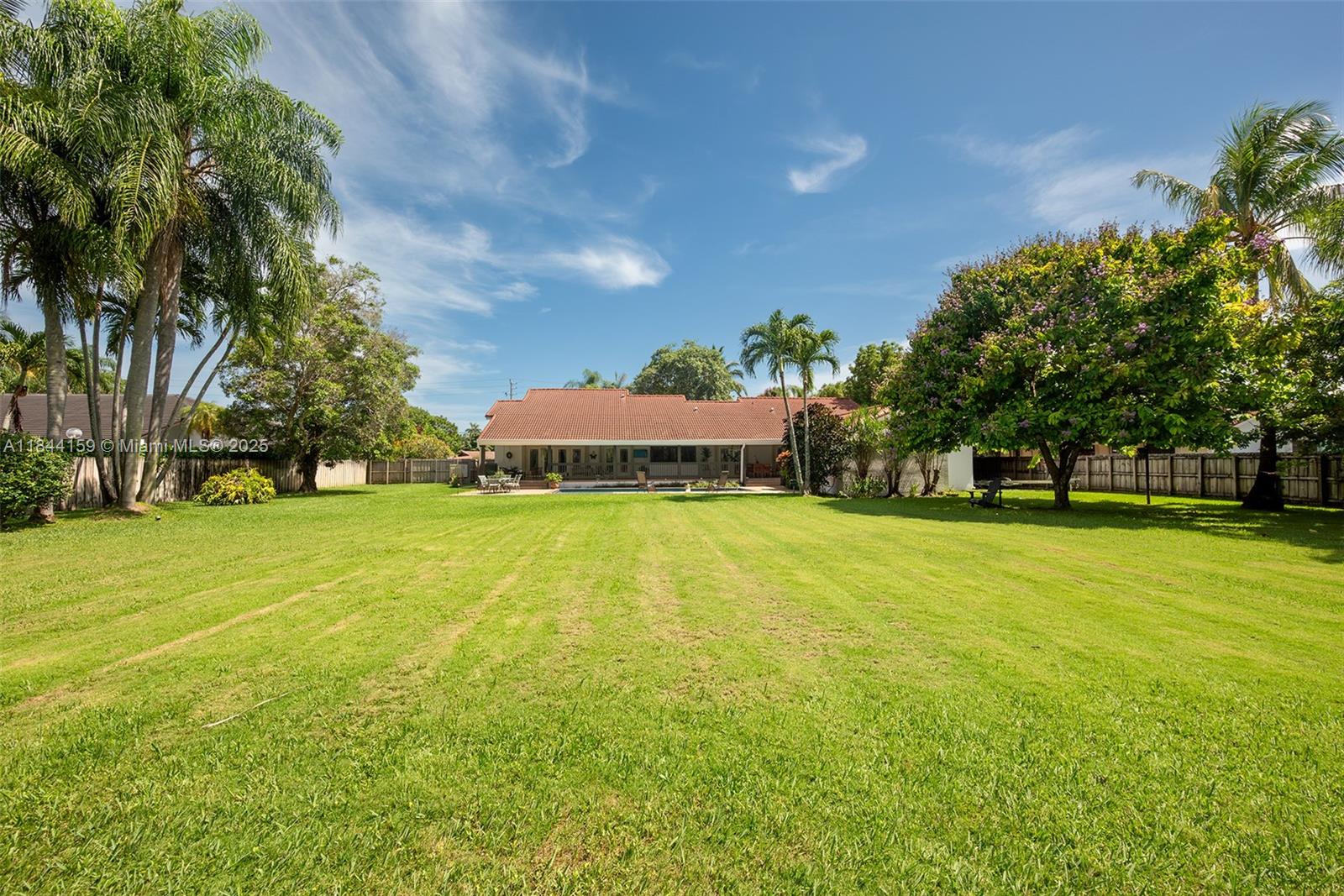8375 Southwest 78th Street Miami, FL 33143 - Photo 42 of 45 a view of a swimming pool and trees in the background