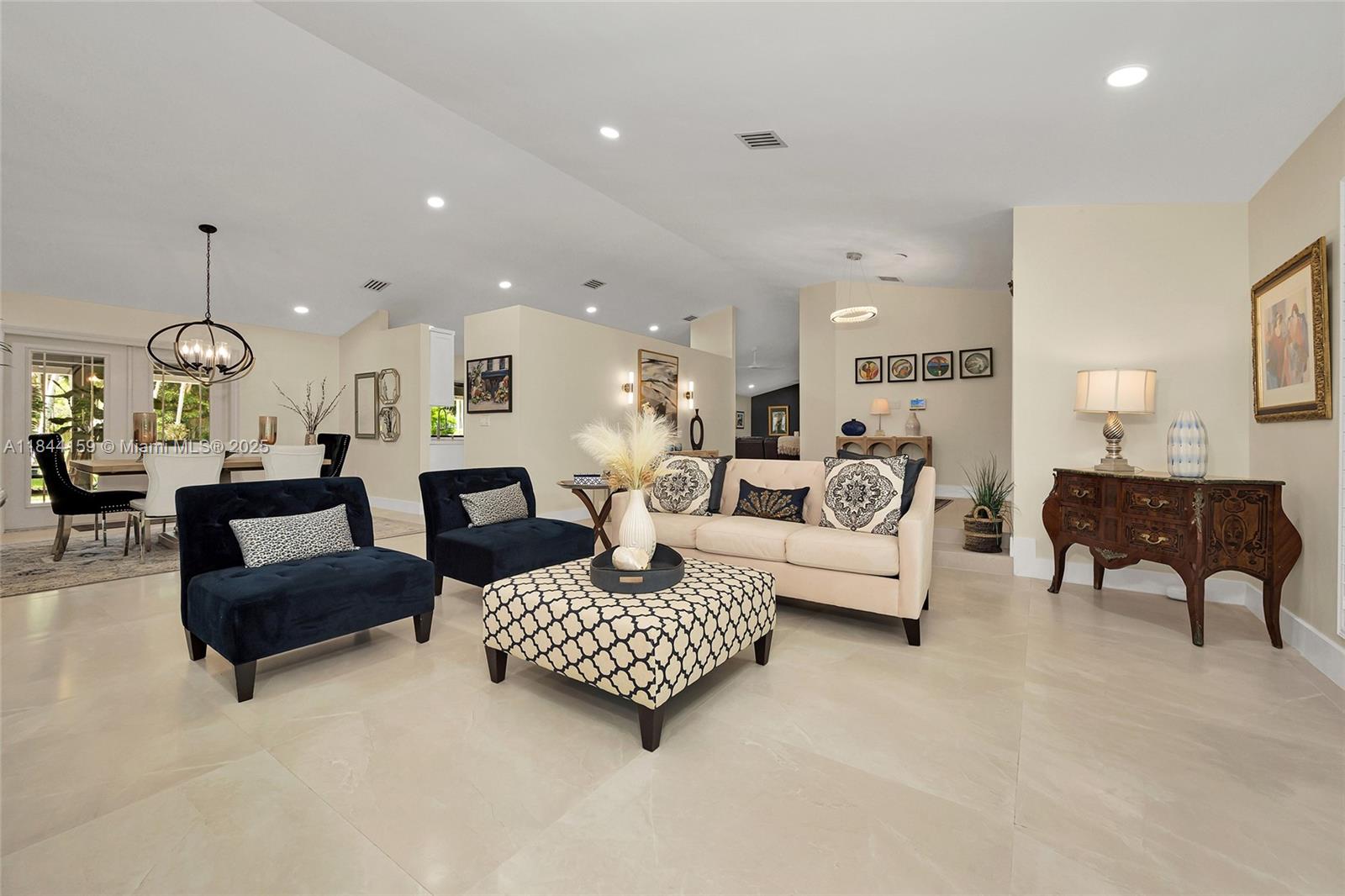 8375 Southwest 78th Street Miami, FL 33143 - Photo 10 of 45 a living room with furniture and a chandelier
