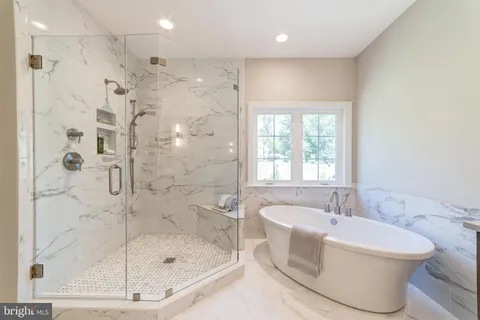 a bathroom with a bathtub and a shower