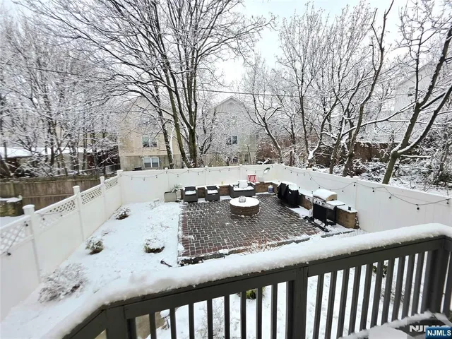 a view of a backyard with snow on the road