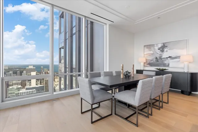 a dining room with furniture and a floor to ceiling window