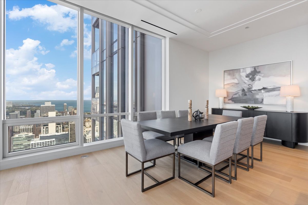 14 West Superior Street, Unit 5003 Chicago, IL 60654 - Photo 11 of 37 a dining room with furniture and a floor to ceiling window