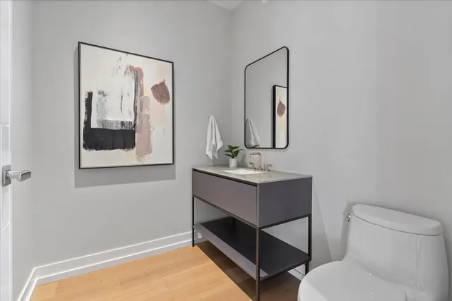 a bathroom with a toilet sink and mirror
