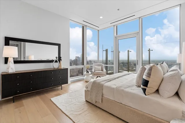 a bedroom with a large bed and a large window