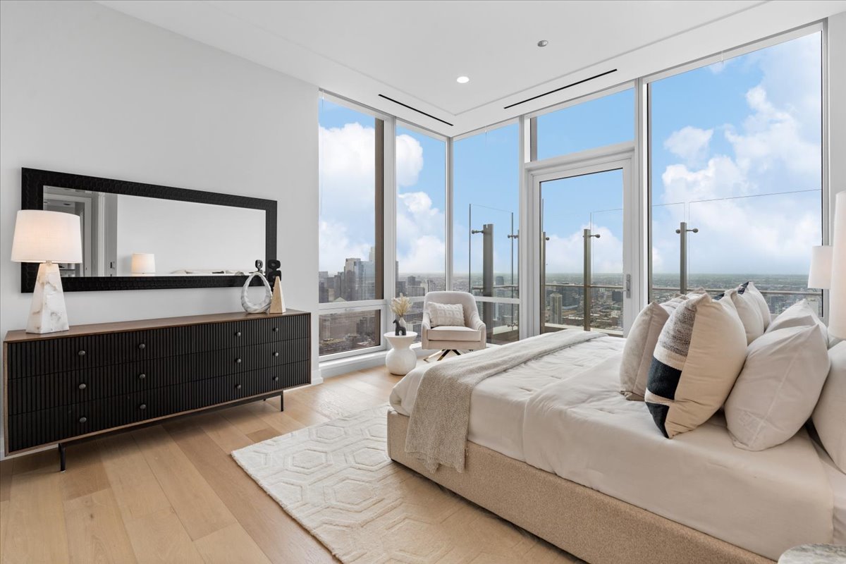 14 West Superior Street, Unit 5003 Chicago, IL 60654 - Photo 13 of 37 a bedroom with a large bed and a large window