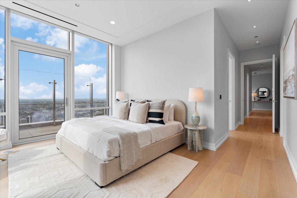 14 West Superior Street, Unit 5003 Chicago, IL 60654 - Photo 15 of 37 a bedroom with a large bed and a chandelier