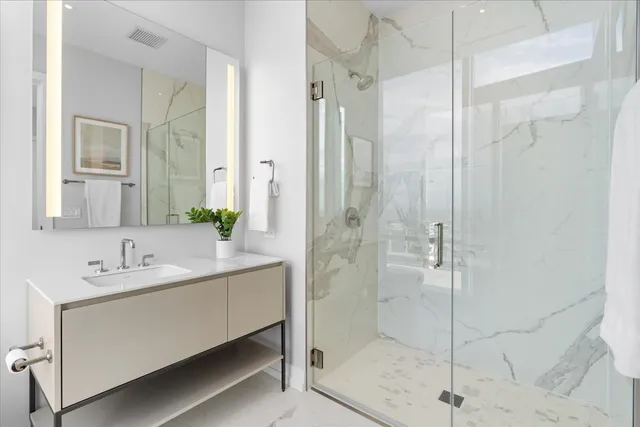 a bathroom with a double vanity sink shower and mirror
