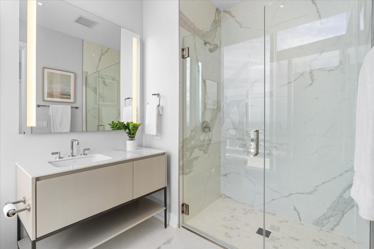 14 West Superior Street, Unit 5003 Chicago, IL 60654 - Photo 19 of 37 a bathroom with a double vanity sink shower and mirror