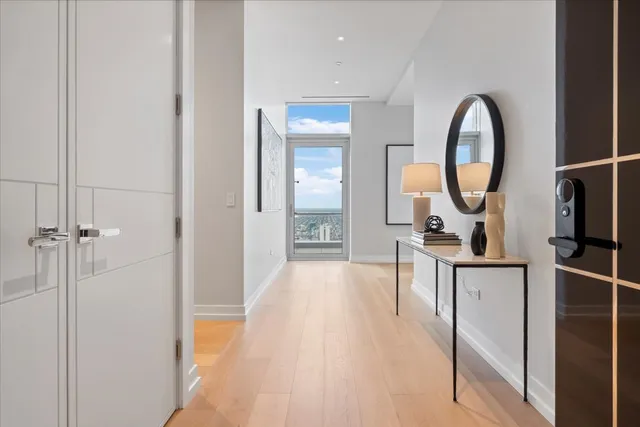 a view of a bathroom with mirror and door