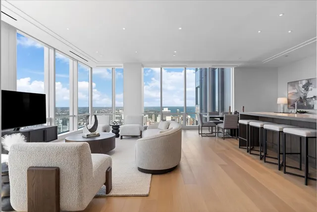 a living room with furniture a flat screen tv and a large window
