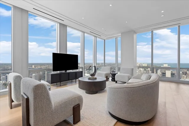 a living room with fireplace furniture and a large window