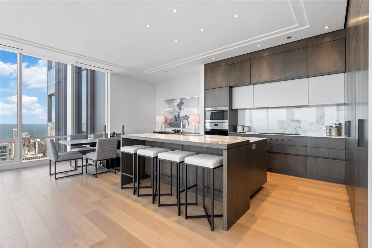 14 West Superior Street, Unit 5003 Chicago, IL 60654 - Photo 8 of 37 a kitchen with stainless steel appliances granite countertop a stove a sink and a microwave