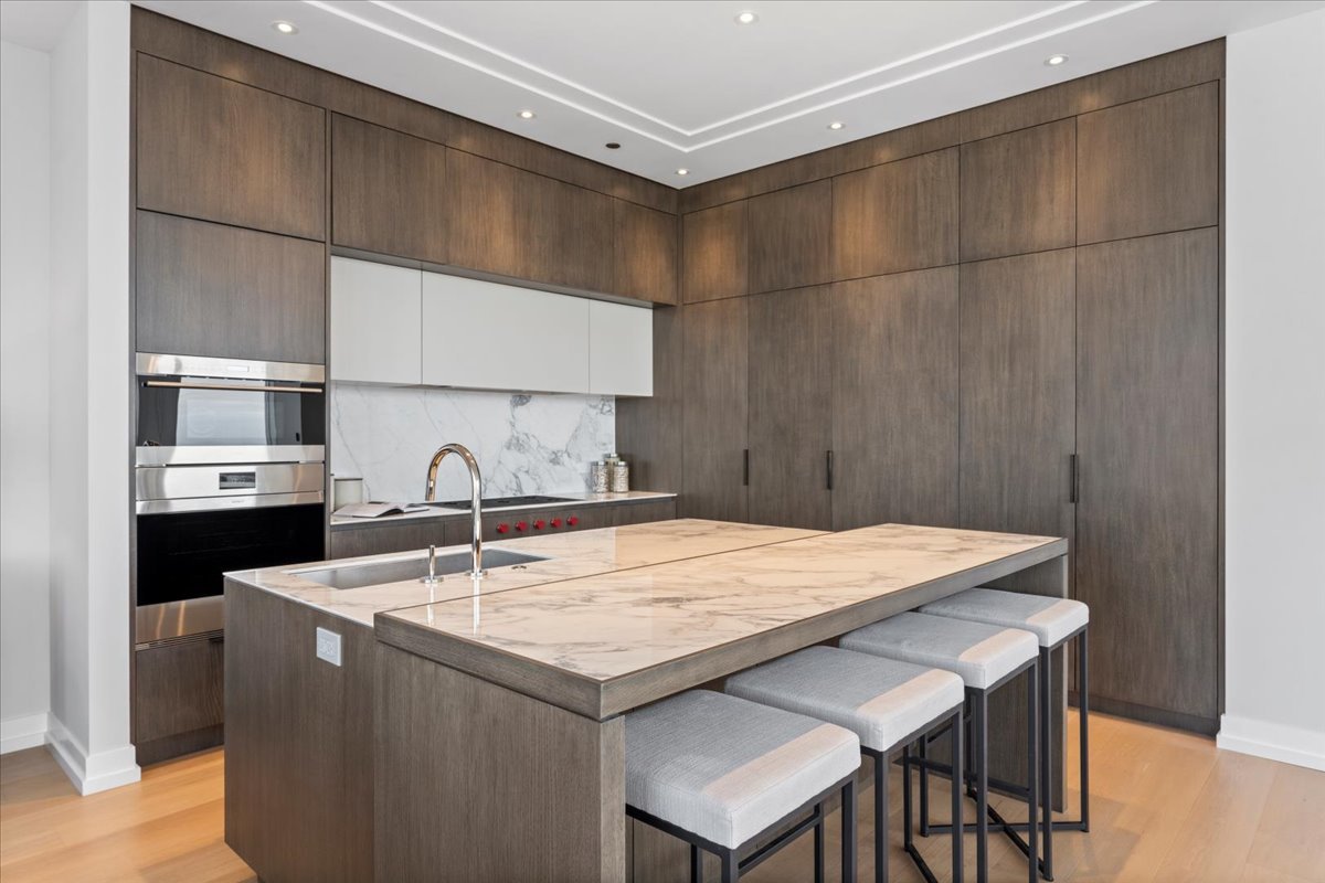 14 West Superior Street, Unit 5003 Chicago, IL 60654 - Photo 9 of 37 a kitchen with a sink a refrigerator and cabinets