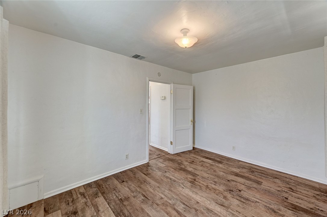 629 L Avenue Boulder City, NV 89005 - Photo 29 of 46 Spare room featuring wood finished floors and baseboards