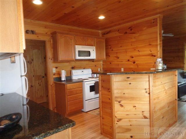 717 F Deep Ford Road Lansing, NC 28643 - Photo 26 of 28 a kitchen with stainless steel appliances kitchen island granite countertop a refrigerator and a stove