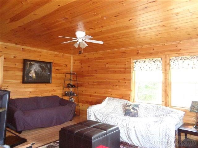 717 F Deep Ford Road Lansing, NC 28643 - Photo 3 of 28 a bedroom with a bed and a chandelier