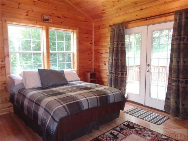 717 F Deep Ford Road Lansing, NC 28643 - Photo 6 of 28 a bed sitting in a bedroom next to a window