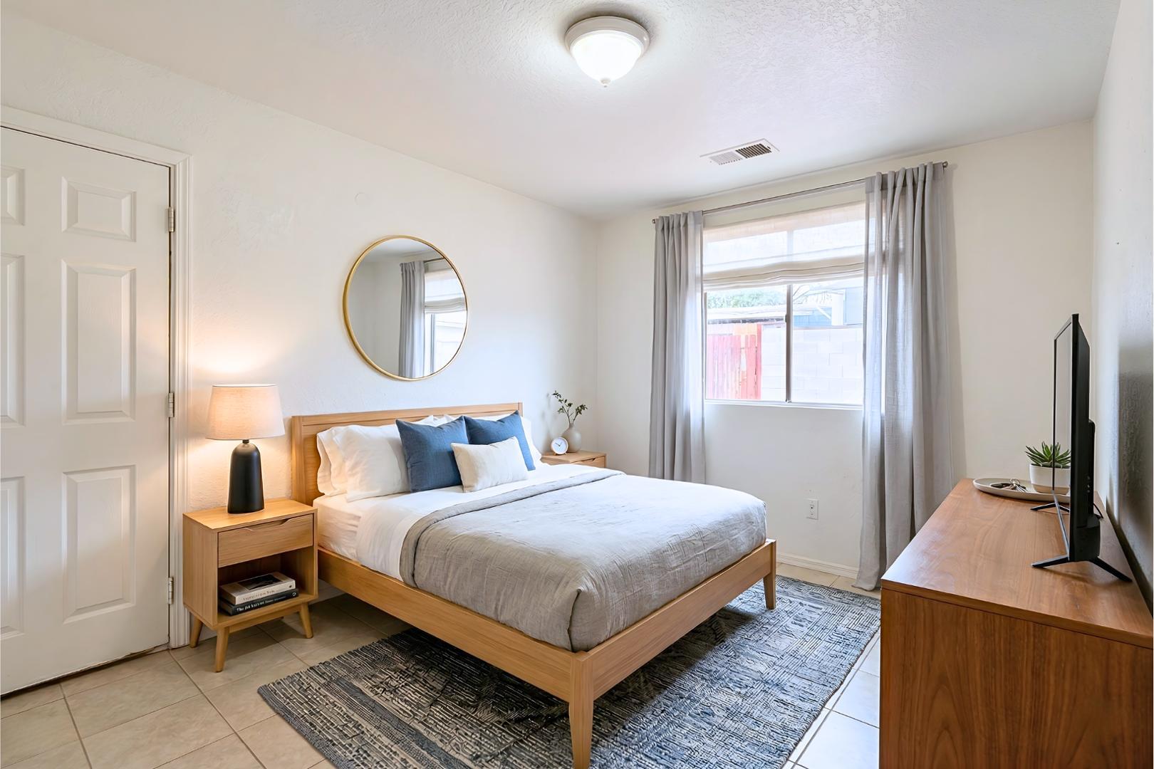 1702 West Shangri-la Road, Unit 3 Phoenix, AZ 85029 - Photo 6 of 7 a bedroom with a bed and wooden floor