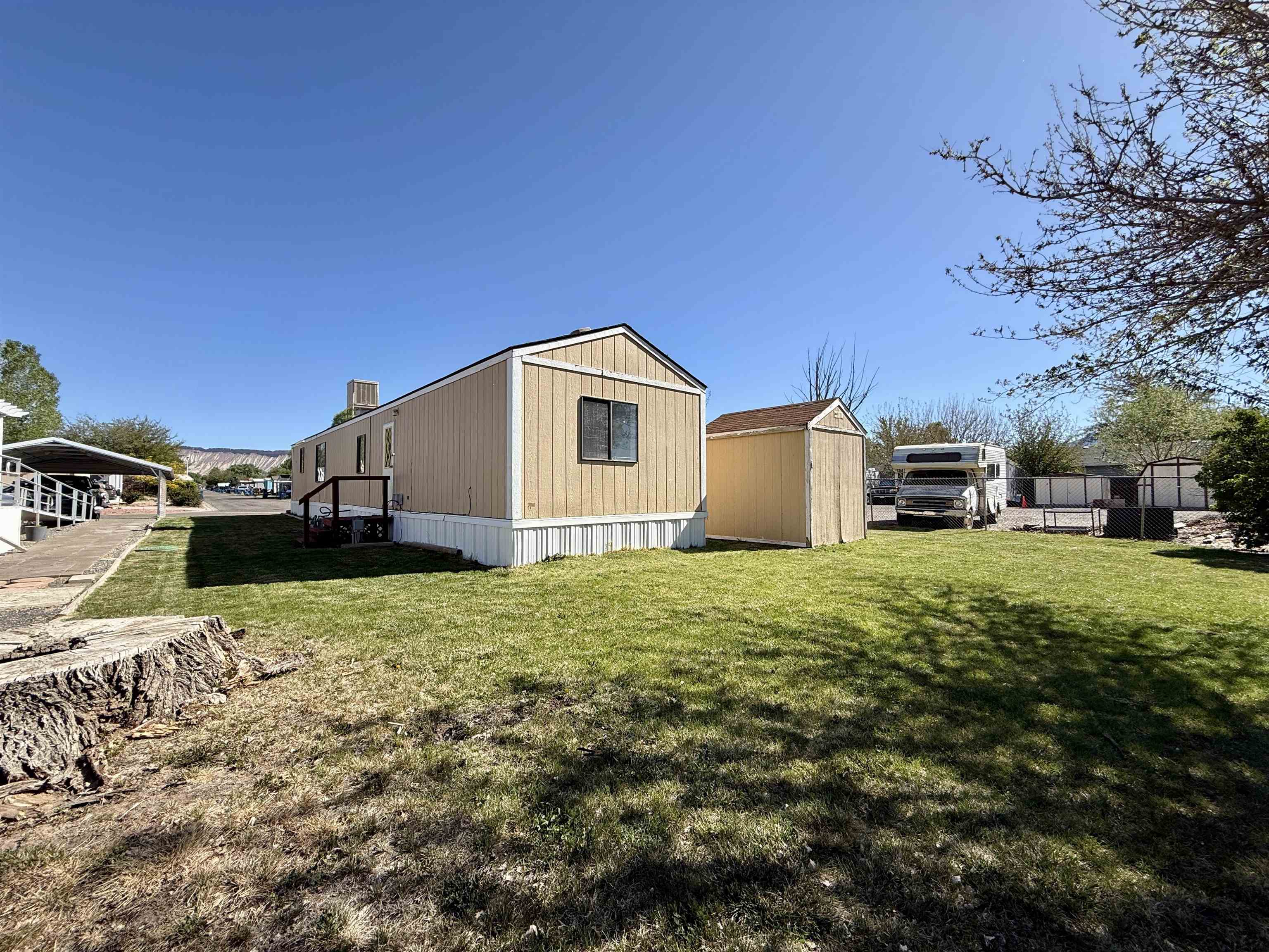 3251 E Road, Unit 33 Clifton, CO 81520 - Photo 26 of 28 a view of a house with a yard