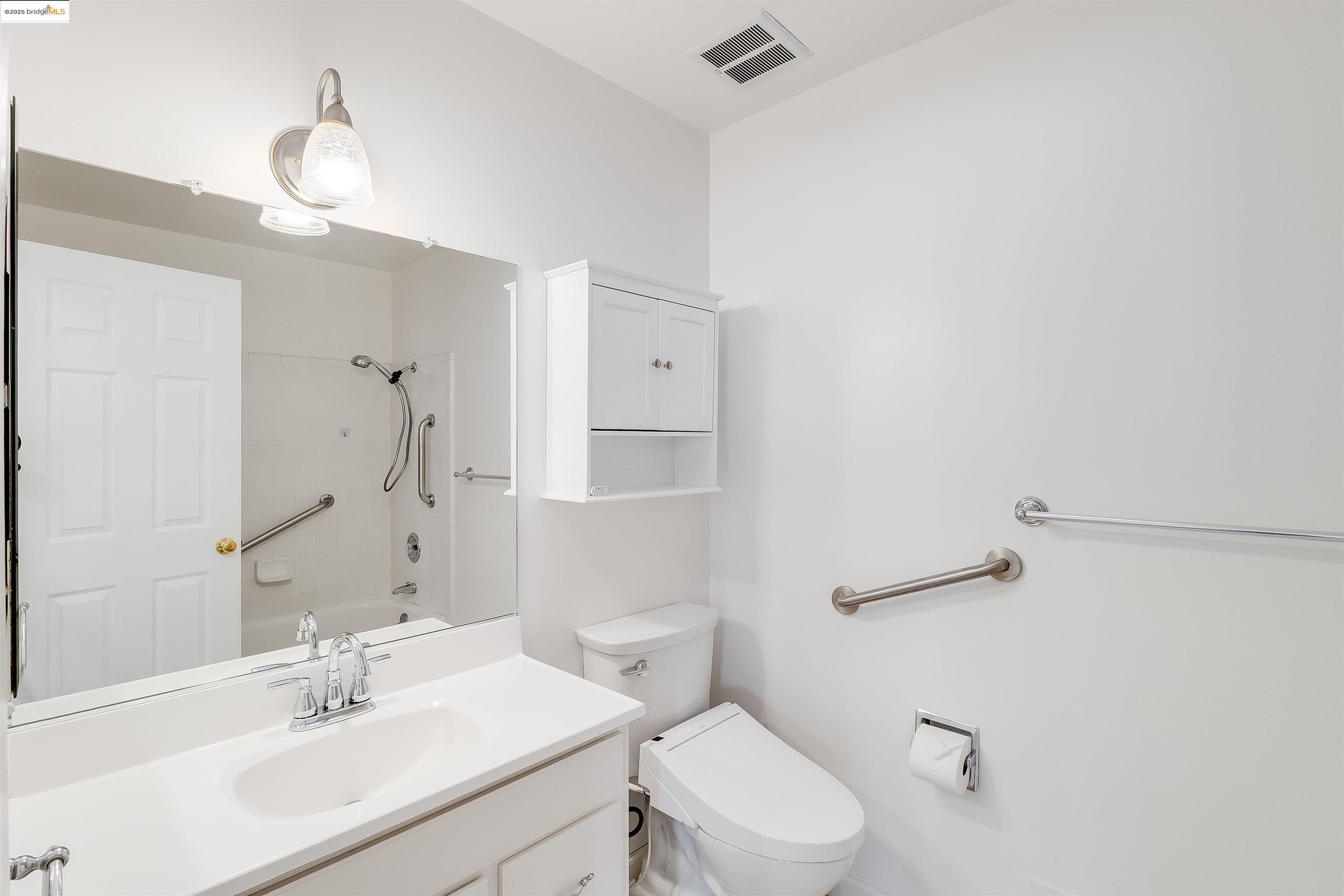 4656 Benbow Court Concord, CA 94521 - Photo 12 of 32 a bathroom with a sink vanity mirror and toilet