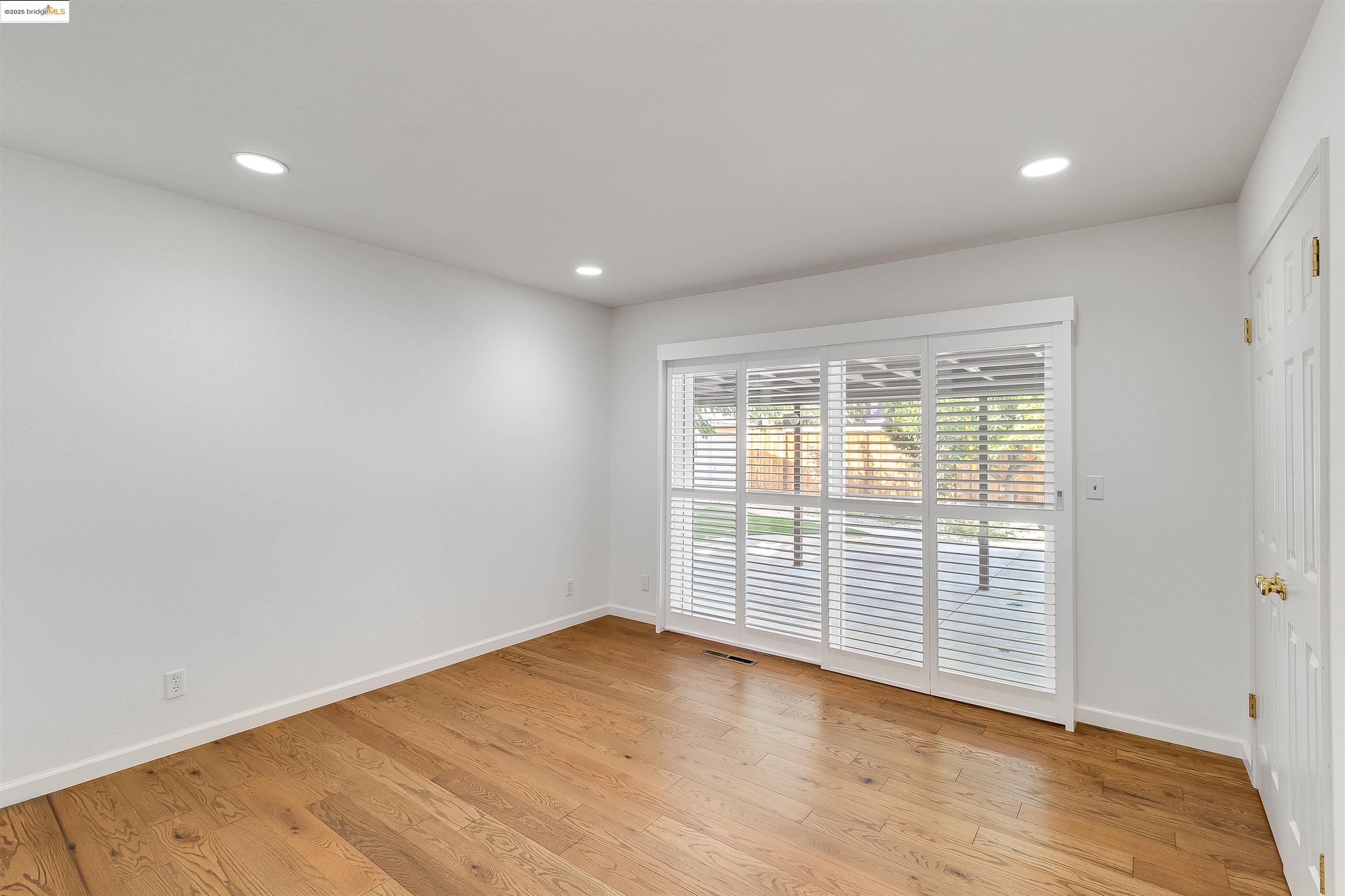 4656 Benbow Court Concord, CA 94521 - Photo 15 of 32 wooden floor in an empty room with a window