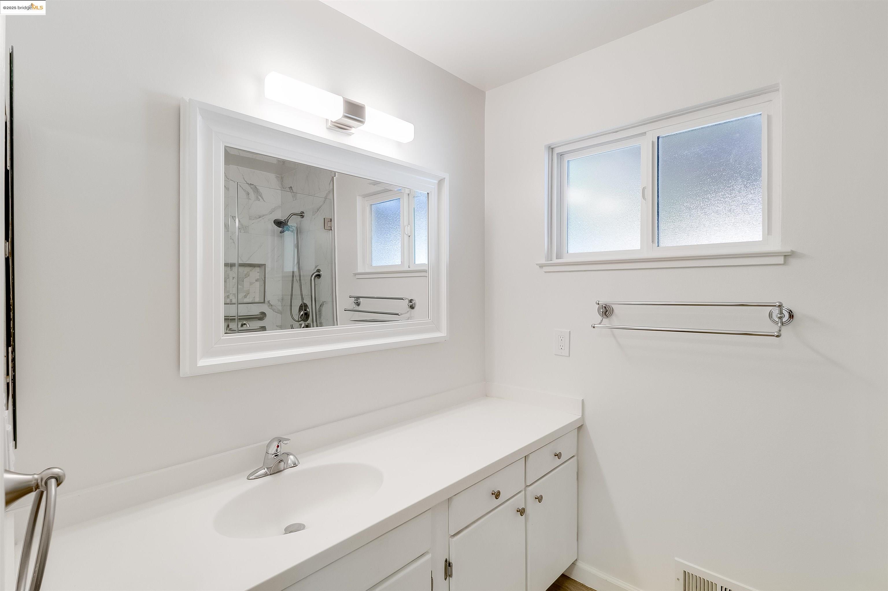 4656 Benbow Court Concord, CA 94521 - Photo 19 of 32 a bathroom with a sink mirror and vanity