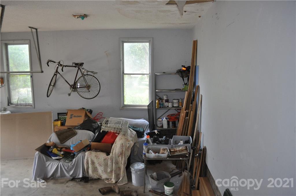 10024 Fireside Lane Charlotte, NC 28215 - Photo 16 of 18 a living room with furniture a window and gym equipment