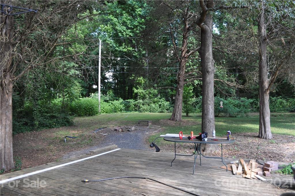 10024 Fireside Lane Charlotte, NC 28215 - Photo 17 of 18 a view of a park with large trees and a barn