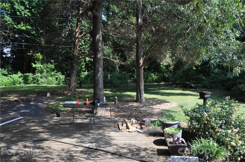 10024 Fireside Lane Charlotte, NC 28215 - Photo 18 of 18 a view of a garden with a bench