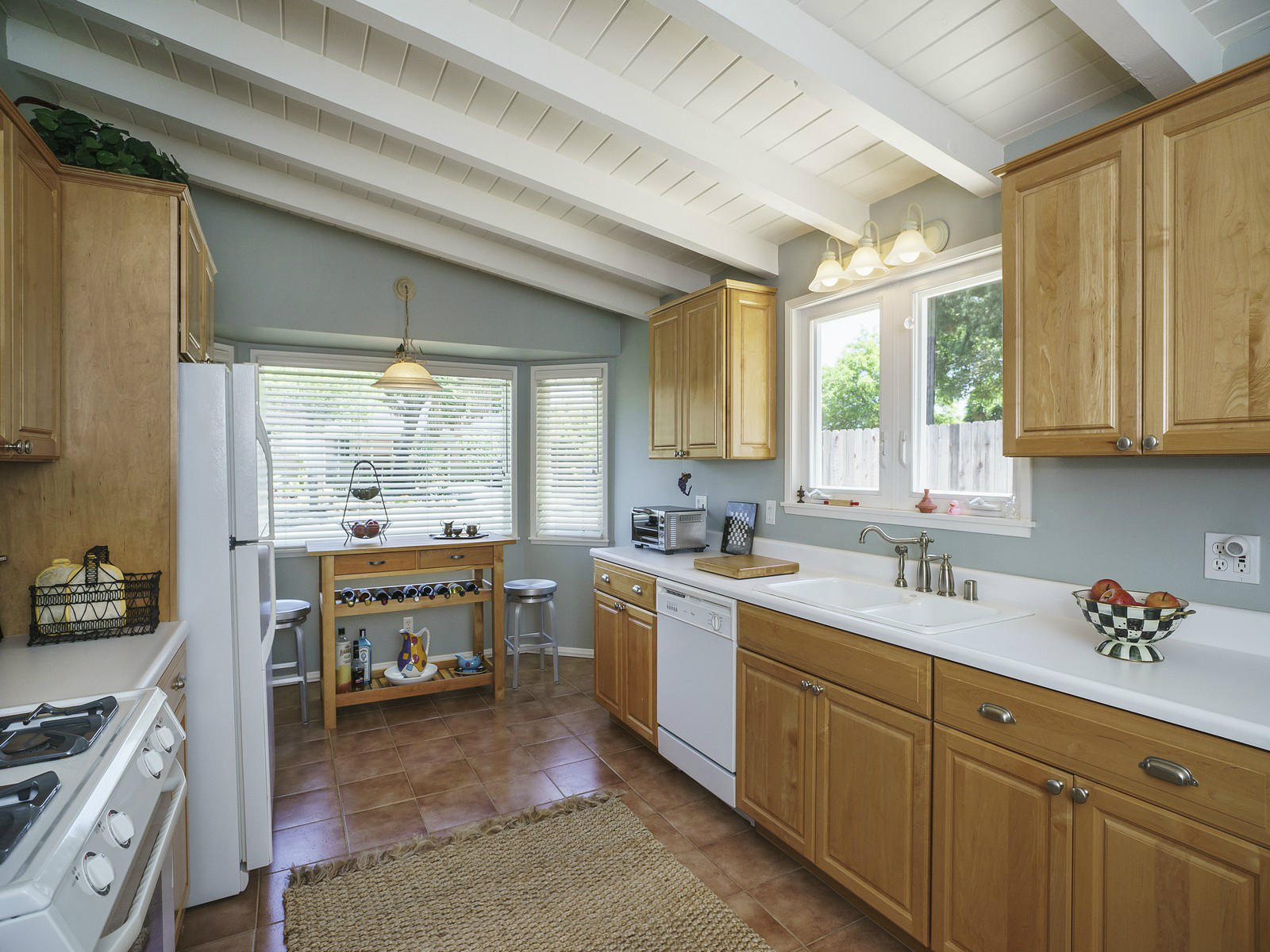 343 Cooper Road Santa Barbara, CA 93109 - Photo 3 of 6 a kitchen with a sink stove and cabinets