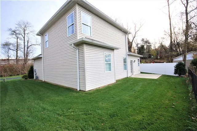a view of a backyard with plants and a garden