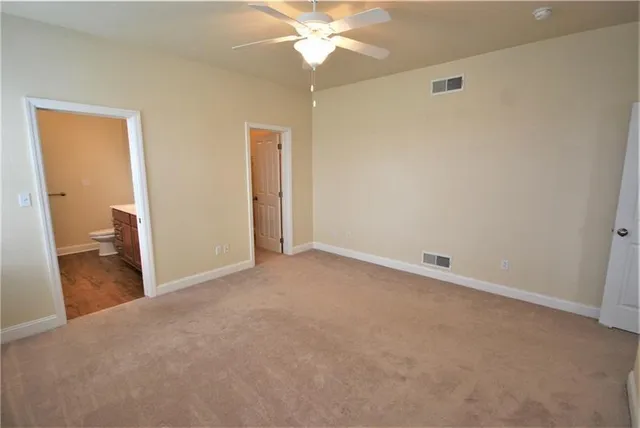 a view of a room with a chandelier fan and entryway