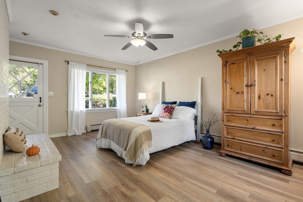 5 Oakwood Road Acton, MA 01720 - Photo 6 of 17 a bedroom with a bed and wooden floor