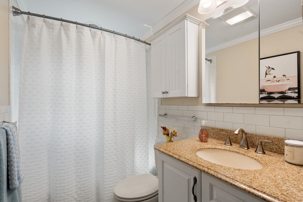 5 Oakwood Road Acton, MA 01720 - Photo 7 of 17 a bathroom with a granite countertop sink and a mirror