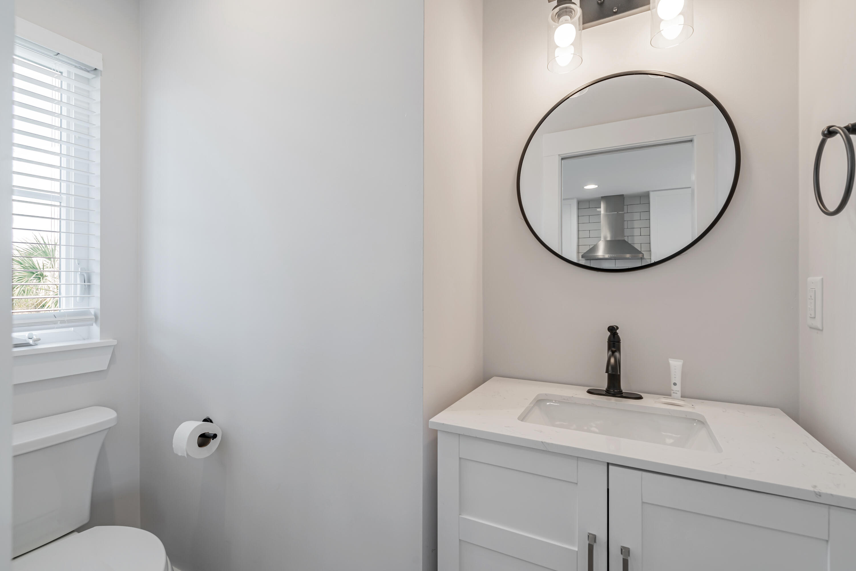 41 Abbie Road Santa Rosa Beach, FL 32459 - Photo 26 of 38 a bathroom with a sink a toilet and a mirror