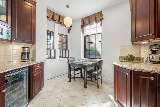 a kitchen with granite countertop a sink and a stove